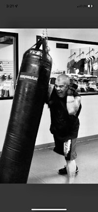 a man is punching a punching bag in a gym